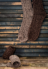 warm knitted socks on wooden background