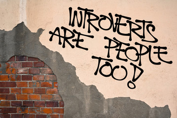 Introverts Are People Too - handwritten graffiti sprayed on the wall - introversion and trouble...