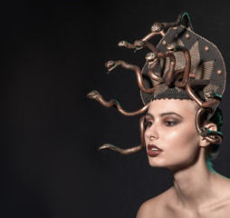 girl Medusa headdress of gold color on a black background
