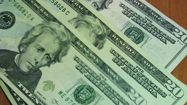 20 Dollars Bills Are Falling On The Table