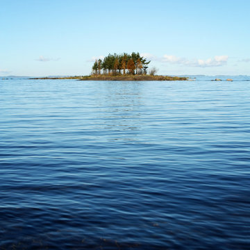 Small island in Ladoga lake near Valaam. Toned photo. Autumn season in Kareliya, Russia.