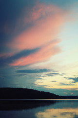 Kenozero lake on an evening. Pink shades of sunset on the clouds. Aged photo. Nature of Russian North. Kenozersky National Park (UNESCO Biosphere Reserve), Russia.