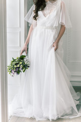 Fototapeta premium Bride. Young women with wedding dress in very bright room, some