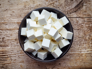 Bowl of soft cheese squares from above © bigacis
