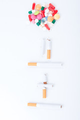 Cigarettes colorful pills and tablets on a white background
