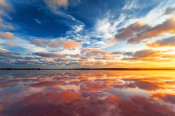 Beautiful sunset landscape. Cloudy sky above salt lake.