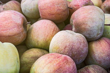 A pile of apples at a farmers market