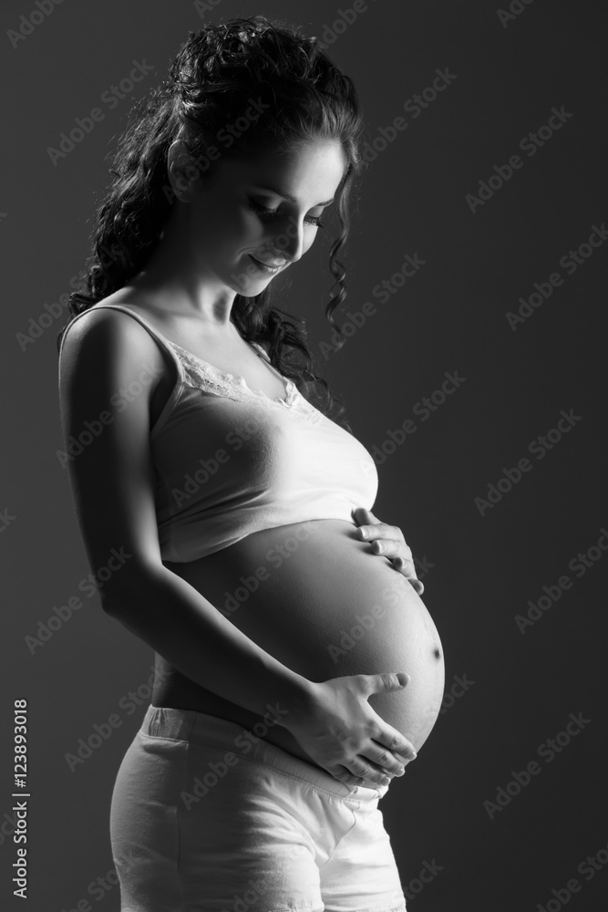 Wall mural belly of pregnant woman monochrome