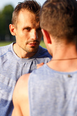 Portrait of two athletes from team supporting each other