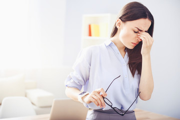 Tired young woman suffering from migraine.