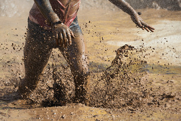 Mud race runners,man running in mud - obrazy, fototapety, plakaty