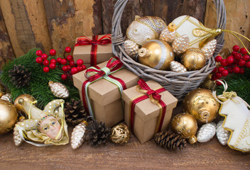 Christmas or New Year background: fur-tree, branches, gifts, colored glass balls, decoration and cones on wooden background