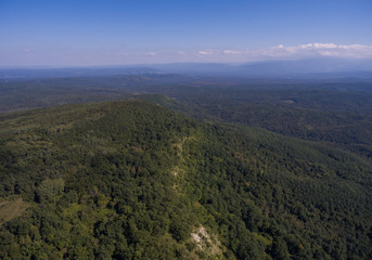 Aerial panorama. Hills covered with forest