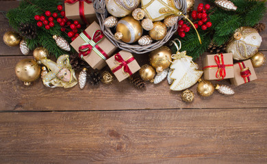Christmas or New Year background: fur-tree, branches, gifts, colored glass balls, decoration and cones on wooden background
