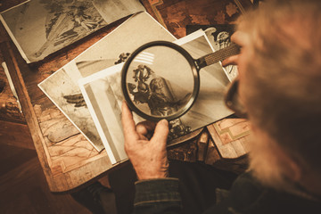 Senior restorer working with antique decor element in his workshop