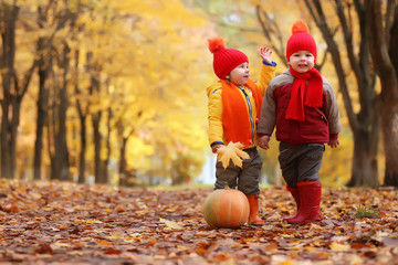 kids in autumn park with pumpkin