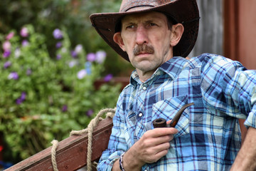 Fototapeta premium cowboy man smoke pipe