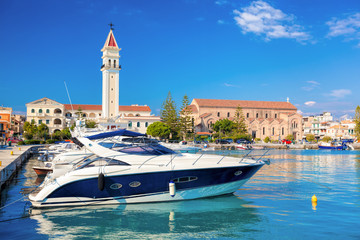 Marina with boats against church in Zakynthos town, Greece