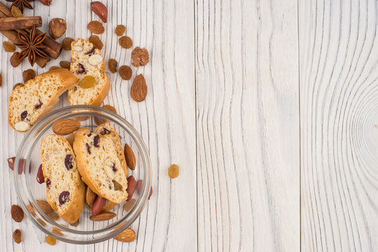 Cookies with almonds and raisins on the old wooden table.