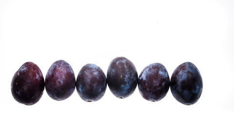 Homegrown organic pile of blue plums isolated on white backgroun