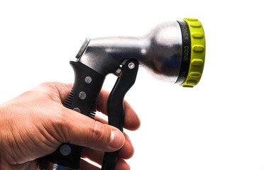 Hand holding a water hose sprinkler with adjustable shower spray