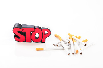 Stop smoking concept, bunch of cigarettes on white background with sign stop