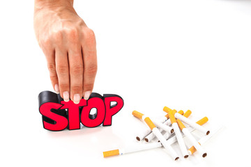 Stop smoking concept, bunch of cigarettes on white background with sign stop