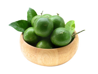 Lime and leave in wood bowl with isolate white background