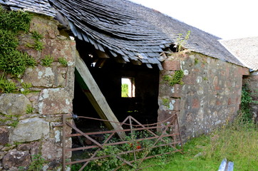 A dilapidated farmhouse which has fallen into ruins