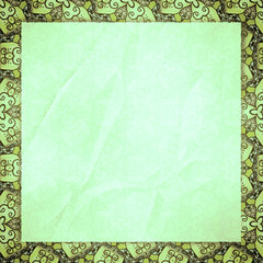 The crumpled form lies on green wall-paper, with an abstract spi