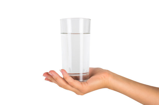 The glass of water in a female hand. On white, isolated background.