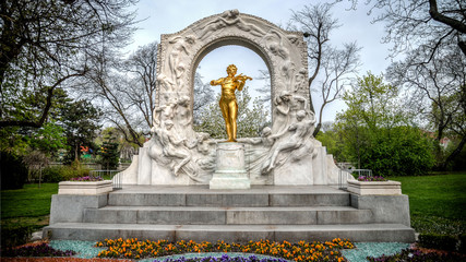 Fototapeta na wymiar Vienna, Austria - April 20, 2013: Golden Statue Of Johann Strauss Playing A Violin In Stadtpark