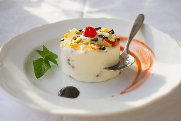 A plated semifreddo dessert topped with glace' fruit