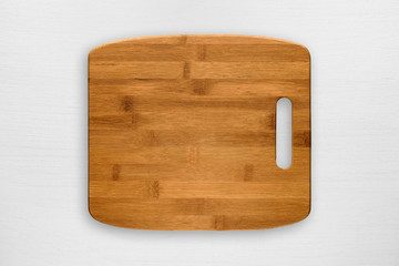 Chopping board on white wooden table top view