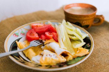 Homemade breakfast of fried eggs and vegetables