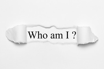 Who am I? on white torn paper