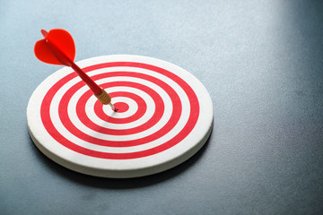 Red bullseye dart with red arrow hit center