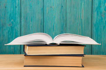 Open book on the desk over wooden background