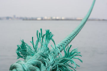 blurred boat rope attached to the pier. Marine rope.