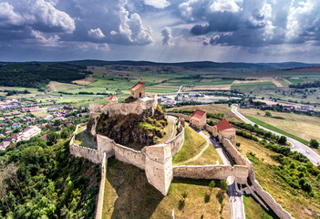 Medieval Fortress Rupea in the heart of Transylvania, Romania. Aerial view from a drone. Rainbow visible in the background.