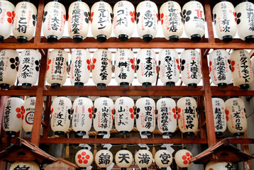 White Japanese paper lanterns hanging in rows