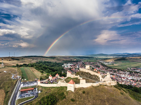 Medieval Fortress Rupea in the heart of Transylvania, Romania. Aerial view from a drone. Rainbow visible in the background.