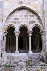 Fototapeta na wymiar sight of the columns, arches and capitals of the courtyard of the cloister of the Romanesque abbey of Santa Maria the Real one in aguilar of Campoo, Palencia, Spain