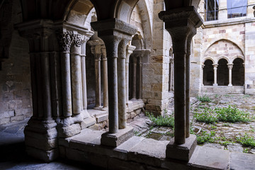 sight of the columns, arches and capitals of the courtyard of the cloister of the Romanesque abbey of Santa Maria the Real one in aguilar of Campoo, Palencia, Spain