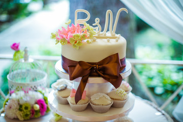 White wedding cake decorated with glaze newlyweds' initials
