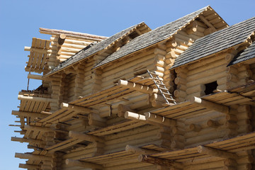 big house building made of wood wooden logs timber under cinstruction