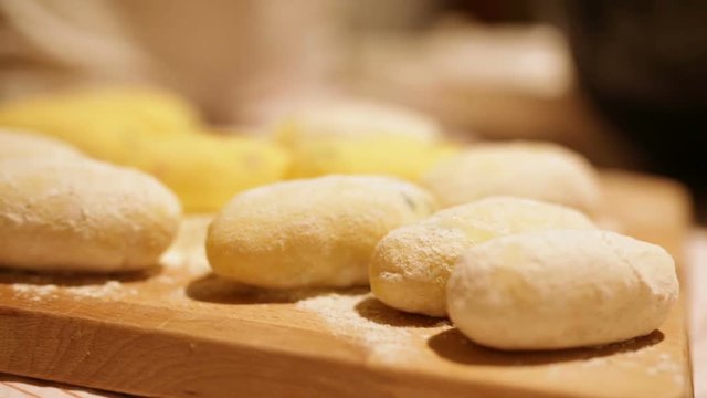 Preparazione crocchette di patate su un tagliere di legno. 