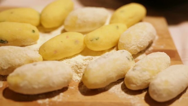 Preparazione crocchette di patate su un tagliere di legno. 