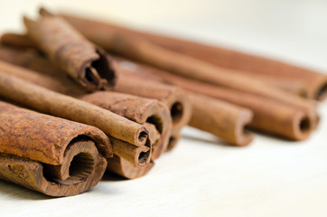 Cinnamon sticks and powder on wood background