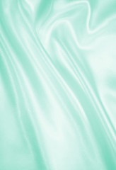 Smooth elegant green silk or satin texture as background